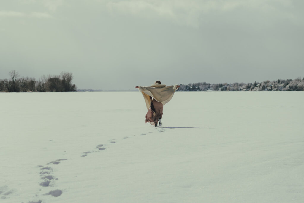 A trail of footprints follow Ali out into the frozen bay.