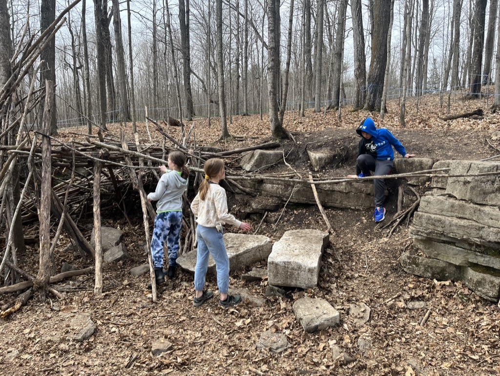 Kids building a stick fort