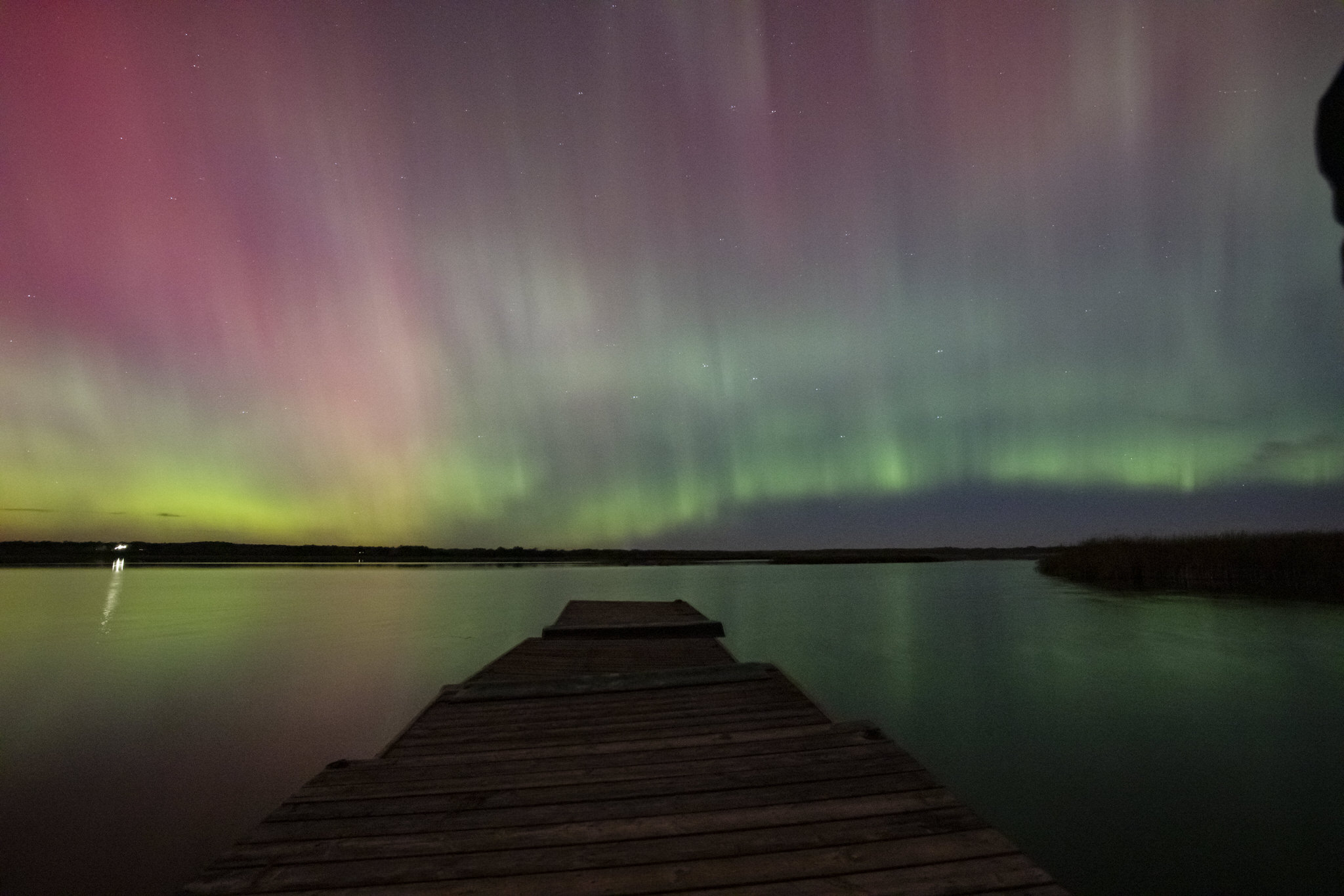 Northern lights, or aurora borealis, reflecting off a lake